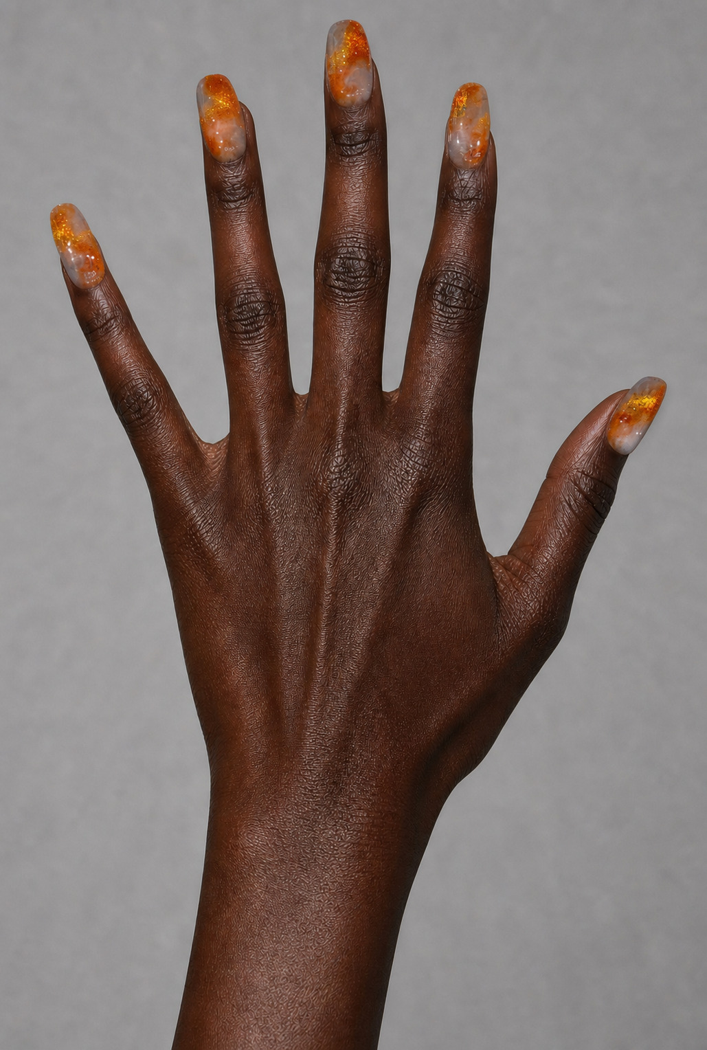 Amber marble on a deep skin tone